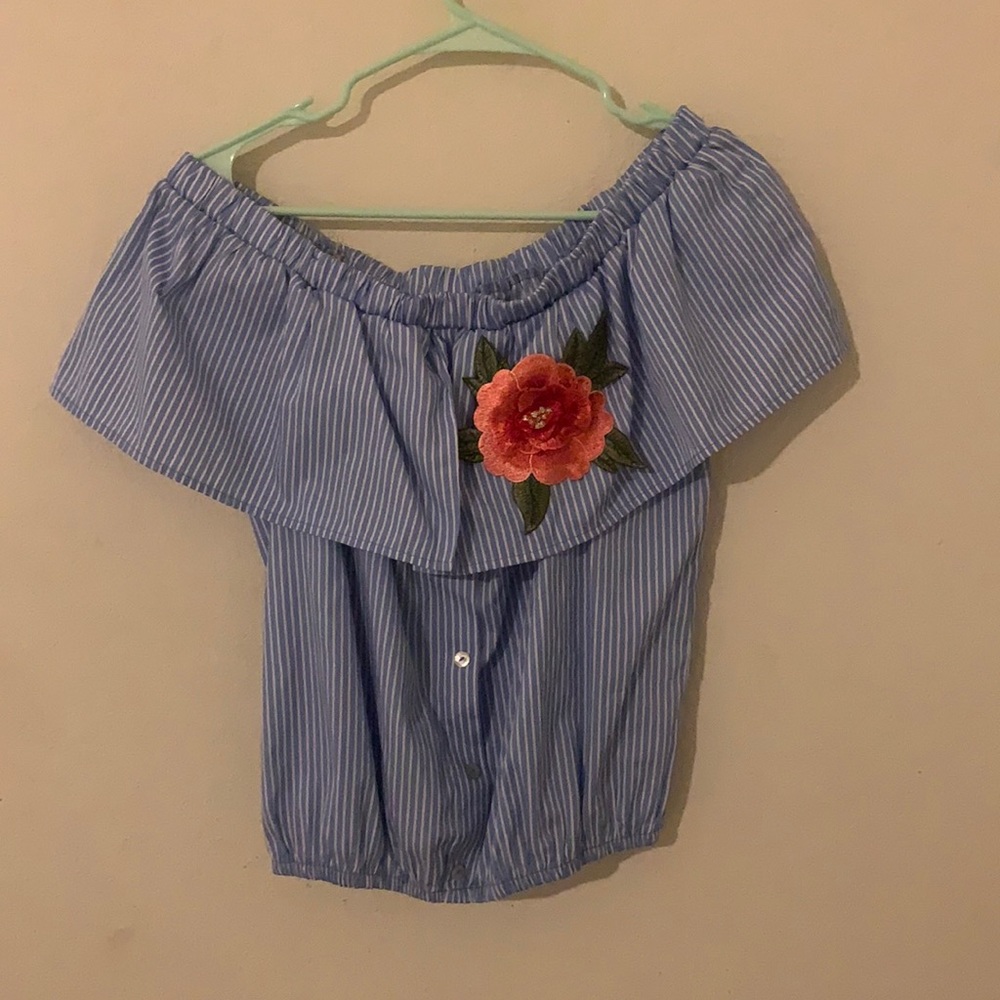 The blue top with the flower on the top left
